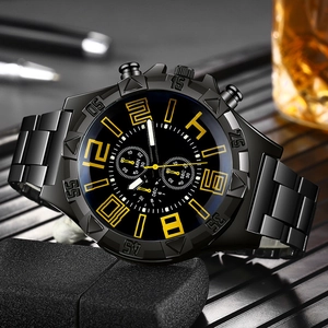 Detail shot of a black steel chronograph watch with yellow accents on a desk setup