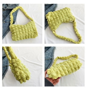 Multi-angle views of a soft popcorn textured bubble bag in pale yellow and green hues