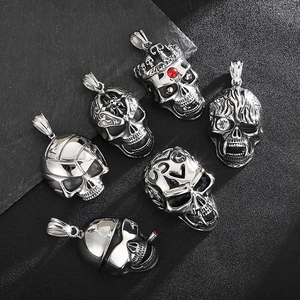 Detail of six vintage steel skull pendants with rhinestones on a dark textured background