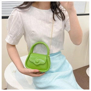Close-up of vibrant lime green mini jelly bag with glossy finish and gold chain strap