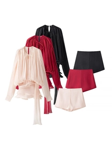 Detailed view of the pleated fabric texture and smooth finish of the two-piece fashion set