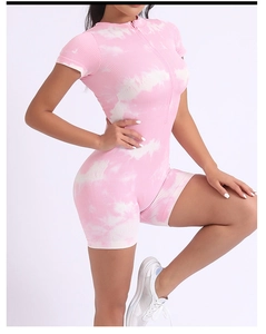 Detail of pink tie-dye yoga romper featuring ribbed texture and front zipper closure