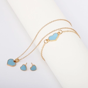 Detail of gold chain jewelry set with blue enamel heart charms on a white background