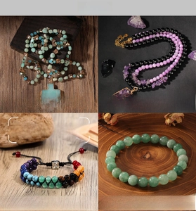 Detail view of 7 Chakra bracelets with amethyst, tiger eye, and natural red agate beads