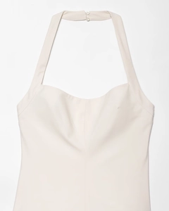 Detail of cream halter neck dress with heart-shaped neckline and button closure