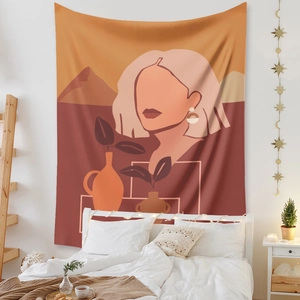 Close-up of Bohemian tapestry featuring abstract female silhouettes and botanical elements