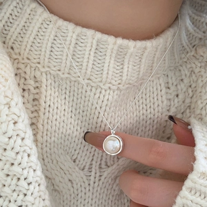 Minimalist 925 sterling silver necklace with freshwater pearl pendant worn on knit sweater