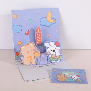 Detail of 3D pop-up birthday card with cartoon animals and cake on a soft purple background