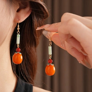 Close-up of elegant Persimmon earrings with colorful beads in a vintage Chinese style