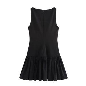 Detailed view of black sleeveless mini dress featuring multi-layered pleated hem design