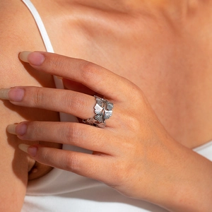 Detail of silver ginkgo leaf ring in stainless steel showing elegant layered leaves