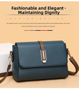 Detail shot of peacock blue lychee grain leather handbag with brown strap and metal clasp