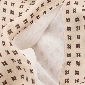 Detail of floral chiffon fabric with geometric print and breathable white lining