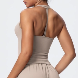 Close-up of nude halter sports bra with thin straps and supportive T-back design