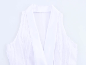 Detail of white sleeveless dress with textured fabric and elegant lapel V-neck design