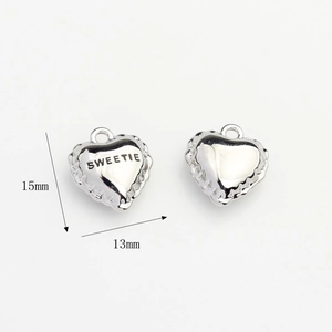 Detail of 15mm heart-shaped zircon charms with Sweetie engraving for DIY jewelry