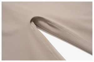 Macro detail of high-elasticity fabric and reinforced flatlock stitching on yoga pants