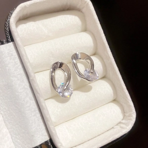 Macro shot of silver studs with irregular hollow frames and sparkling round cubic zirconia
