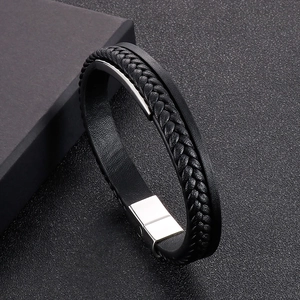Close-up of triple-layer leather bracelet with braided strands and magnetic metal clasp