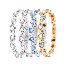 Detail view of heart-shaped crystal magnetic therapy bracelets in multiple colors
