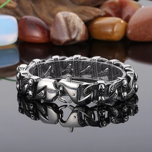 Macro shot of a gothic skull cuban chain bracelet in stainless steel on stone background
