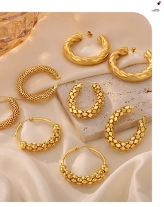 Detail of various vintage gold hoop earrings with twisted and textured metal finishes