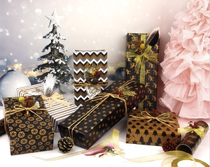 Christmas wrapping paper with black gold reindeer, snowflake and wave pattern designs