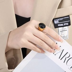 Detailed view of chunky gold plated ring with large faceted black glass stone for women