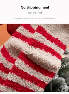 Detail of red and white striped coral fleece socks with anti-slip heel design for winter