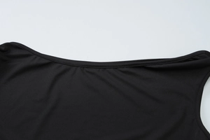 Detail shot of black round neckline and fine stitching on a sleek polyester top