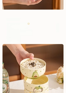 Detail of hand holding a cute ceramic bowl with fruit patterns for rice and dessert