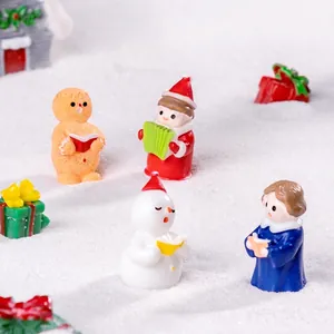 Christmas miniature choir figurines set with snowman and gingerbread man in snow scene