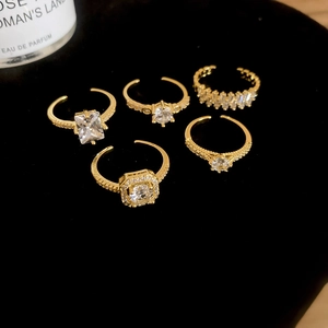 Detailed view of 5-piece gold adjustable ring set with square and round cubic zirconia