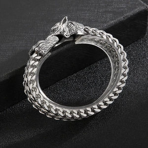 Detailed view of silver Viking wolf head clasp on a double chain stainless steel bracelet