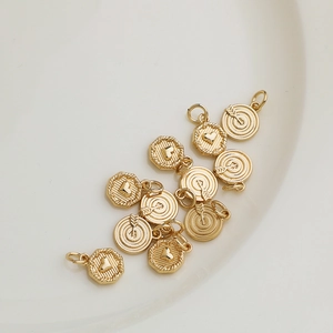 14K gold plated heart and star charms for DIY jewelry making displayed on a white plate