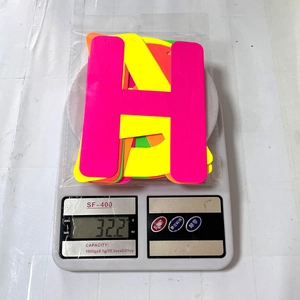 Weight display of neon Happy Birthday party banners showing approximately 32.2 grams