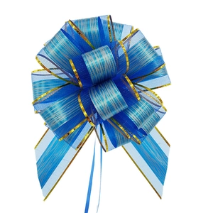Detailed view of a blue translucent gift pull bow with gold stripes and elegant gold trim