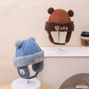 Detail of plush bear ear winter hats for babies featuring thick fleece lining and embroidery