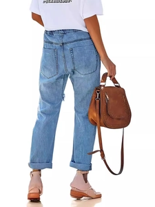 Rear view of light blue distressed jeans with elastic waist and white printed T-shirt