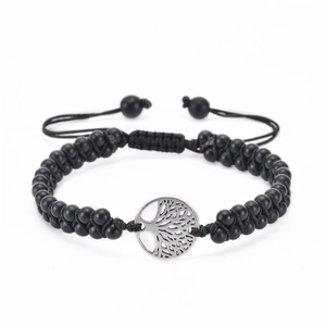 Close-up of double-row black matte beads with silver Tree of Life pendant and cord