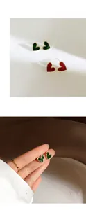 Detailed close-up of S925 silver heart stud earrings in green and red with gold trim