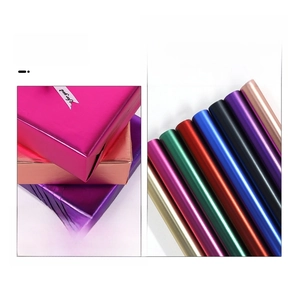 Macro detail of high-end metallic matte gift wrapping paper rolls in multiple vibrant colors