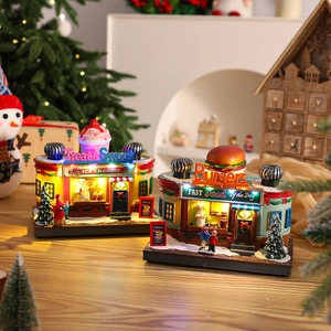 Lighted Christmas music box village scene with miniature Santa sweet shop and burger house