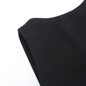 Macro detail of fine fabric texture and neat stitching on black backless maxi dress