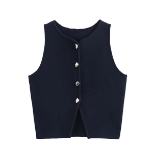 Detail of navy knit vest showing textured fabric and silver irregular metal buttons
