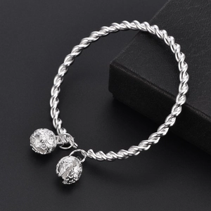 Silver twisted rope open bangle bracelet with two vintage hollow bell charms on black box