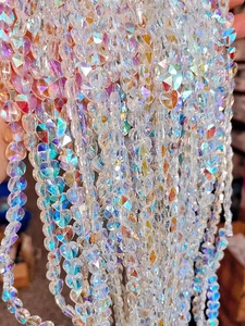 Macro detail of faceted iridescent heart-shaped crystal beads for DIY jewelry making
