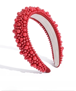Detailed view of Baroque headband with glossy red pearls and soft gray inner lining