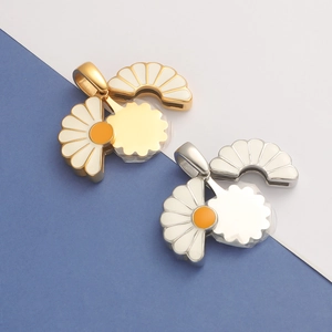 Detail of openable sunflower locket pendants in gold and silver with white enamel petals
