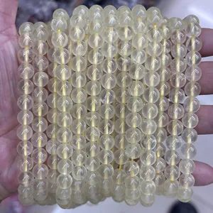 Macro shot of natural yellow phantom quartz beads showing clear texture and transparency